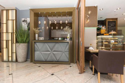 a bar in a restaurant with a table and chairs at 3 City Hostel in Gdańsk