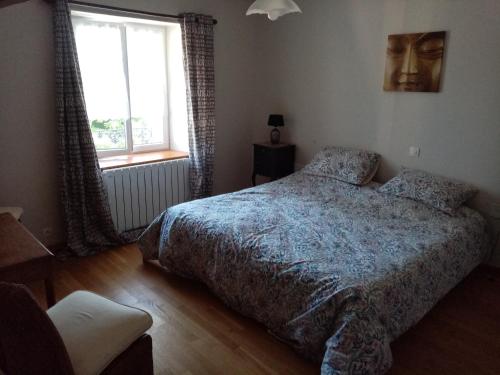 a bedroom with a bed and a window at La Parisiere in Gavray