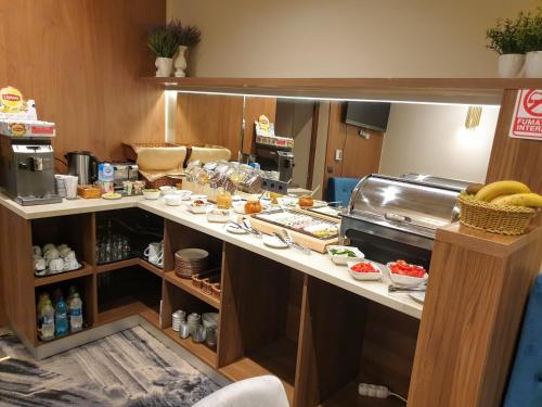 a kitchen with a counter with food on it at Vila Siago in Cluj-Napoca