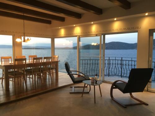 a dining room with a view of the water at THE VIEW **** in Račišće