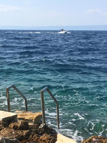 a boat in the ocean with a boat at THE VIEW **** in Račišće