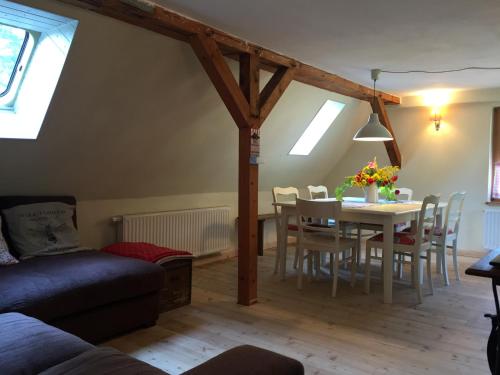 a living room with a table and a dining room at Pfarrhof Stuer in Stuer