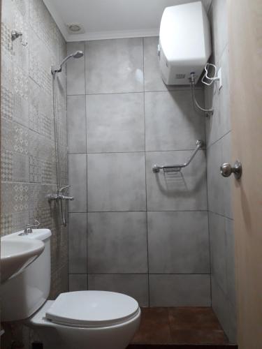 a bathroom with a toilet and a shower stall at Stone Wasi in Montevideo