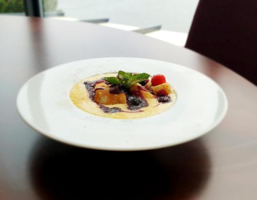 a white plate with a dessert on a table at Hotel Eurobus in Kaluža