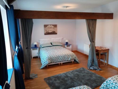 a bedroom with a bed with a canopy at La Parisiere in Gavray