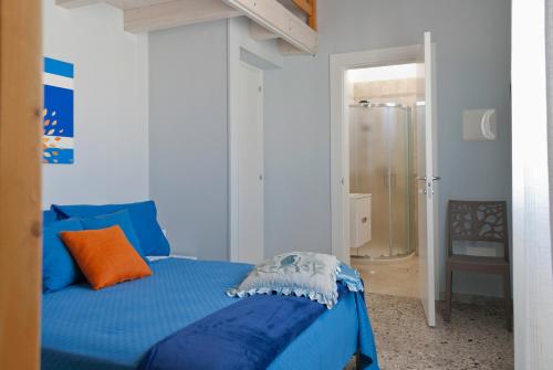 a bedroom with a blue bed and a shower at B&B Mamma Carolina in Sanarica
