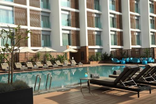 a hotel swimming pool with lounge chairs and a building at Barceló Anfa Casablanca in Casablanca