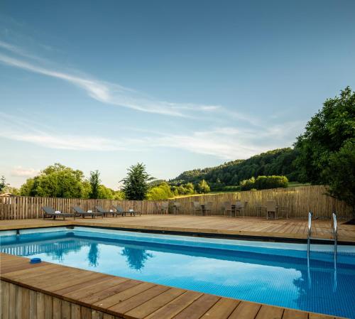 a swimming pool in a yard with a wooden deck at Willa Wzgórze Poręba in Długopole-Zdrój