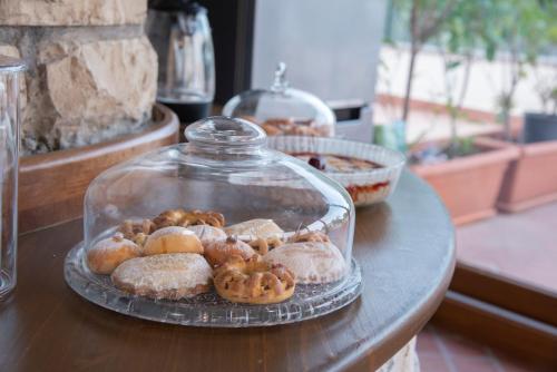 a display of donuts in a glass jar on a table at Boutique Villa Etna d'A'mare in Trecastagni