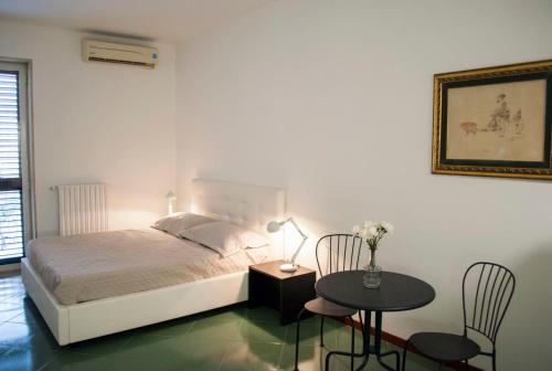 a bedroom with a bed and a table with chairs at Fanfulla in Monopoli