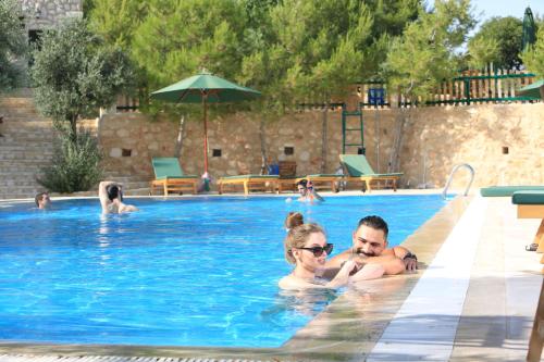 a man and a woman in a swimming pool at Mountain Breeze Lodge & Resort in Al Salt