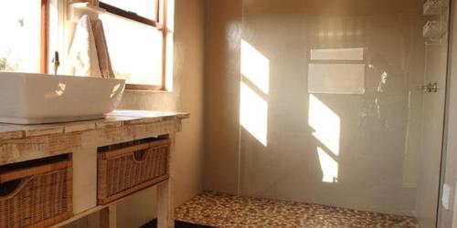 a bathroom with a sink and a shower with a window at Donkerhoek Country Living in Avondzon