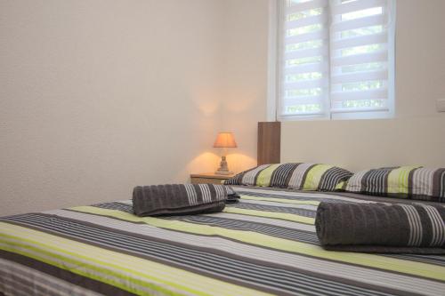 Voodi või voodid majutusasutuse Apartmani Galešić toas