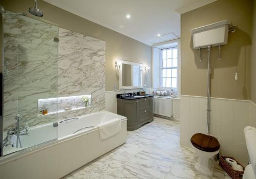 a large bathroom with a tub and a sink at Glenburnie at Thirlestane Castle in Lauder
