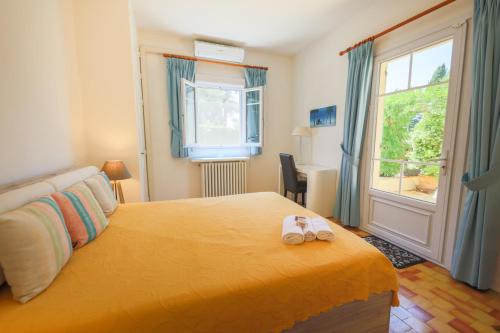 a bedroom with a bed with two slippers on it at VILLA LES ONDES VI4120 in Juan-les-Pins