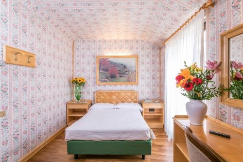 Postel nebo postele na pokoji v ubytování Albergo Italia
