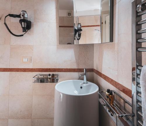 a bathroom with a sink and a mirror at Residenza Ducato Corte Contarina in Venice