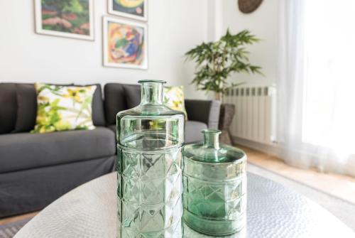 two glass vases sitting on a table in a living room at Plaza de España Skyline in Madrid