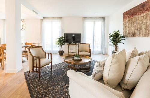 a living room with a couch and a table at Plaza de España Skyline in Madrid