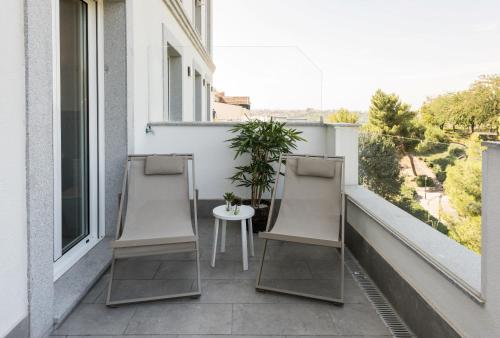 two chairs and a table on a balcony at Plaza de España Skyline in Madrid