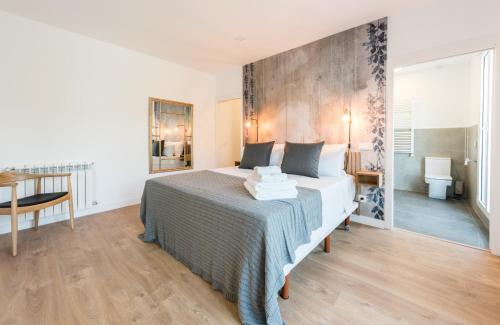 a bedroom with a bed and a table in a room at Plaza de España Skyline in Madrid