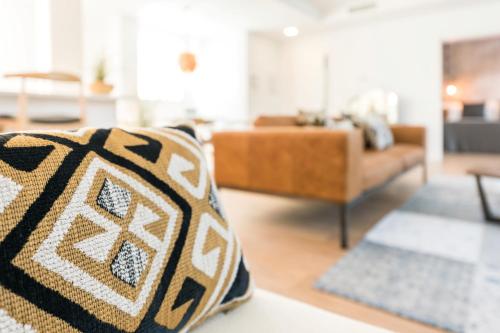 a living room with a couch and a pillow at Plaza de España Skyline in Madrid