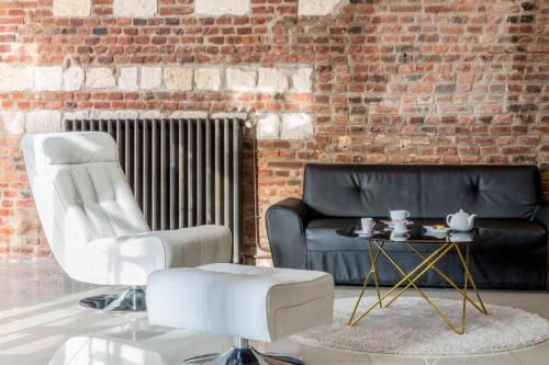 a living room with a couch and a table at Best Western Hotel Saint Claude in Péronne