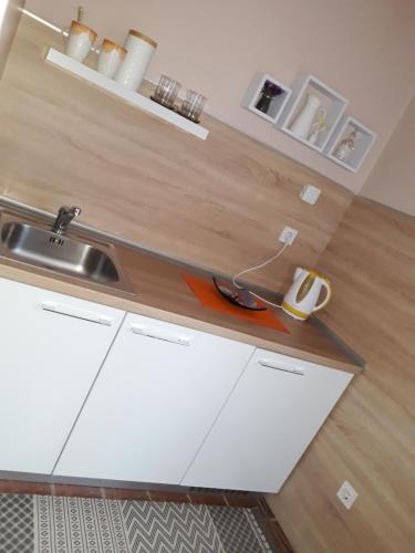 a kitchen with a sink and a wooden counter top at Apartmani RALE rooms in Sarajevo