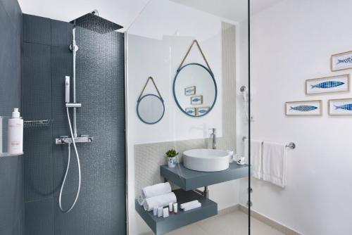 a bathroom with a sink and a shower at VOI Colonna Village in Golfo Aranci