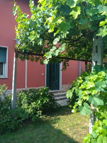 a red house with stairs leading to a door at Bella di notte in San Giorgio a Liri