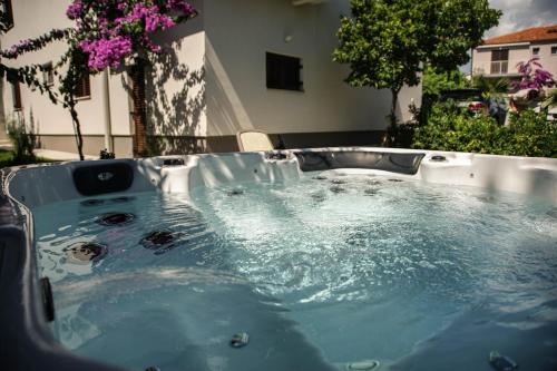 a jacuzzi tub with water in a yard at Apartments Medora in Rovinj