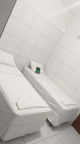 a white bathroom with a toilet in a room at Hotel do Hulk in Barreirinhas