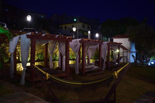 a gazebo in a yard at night at Hotel Recanto do Ouro in Ouro Preto