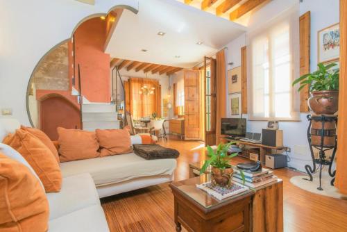 a living room with a couch and a table at Miraclet - ADULTS ONLY in Palma de Mallorca