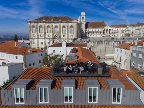 a group of people sitting on the roof of a building at Sapientia Boutique Hotel in Coimbra