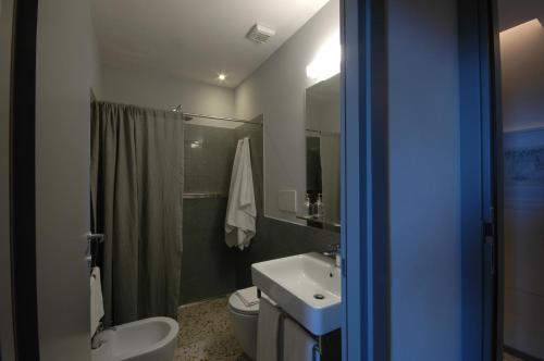 a bathroom with a white toilet and a sink at Croce Suite with Terrace in Porto Santo Stefano
