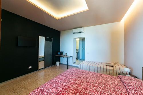 a bedroom with a bed and a table in it at Croce Suite with Terrace in Porto Santo Stefano