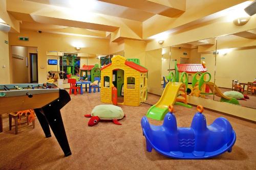 a childrens play room with a pool table and play equipment at Grand Hotel Stamary in Zakopane