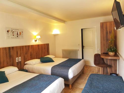 A bed or beds in a room at Hostellerie De Bretonnière - Groupe Logis Hotels