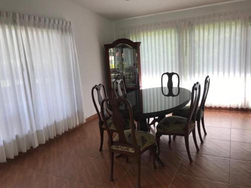 a dining room with a table and chairs and a mirror at FINCA EL RECUERDO in Gachetá