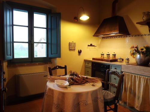 a kitchen with a table with a table cloth on it at Cortona Resort-Le Terre Dei Cavalieri in Cortona