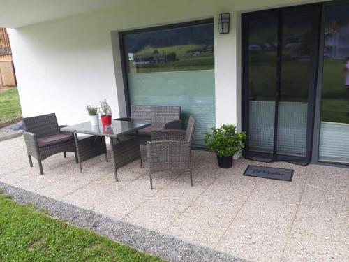 a patio with a table and chairs on a house at Barschtlerhof in Axams