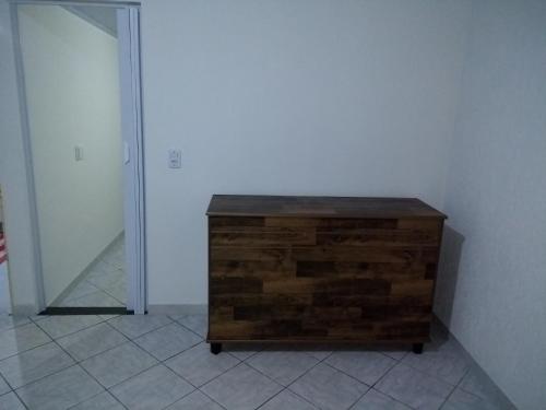 a wooden dresser sitting in a corner of a room at Pouso do Beija-Flor in Cavalcante