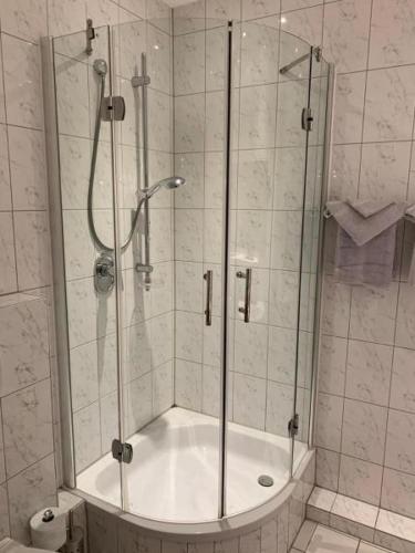 a shower with a glass door in a bathroom at Burg Wassenberg in Wassenberg