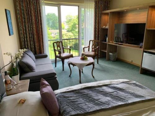 a bedroom with a bed and a living room at Burg Wassenberg in Wassenberg