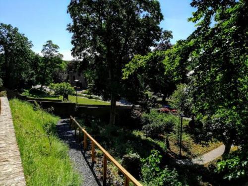 a view of a park with trees and a fence at Burg Wassenberg in Wassenberg