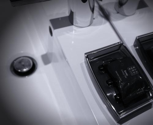 a white counter top with an electronic device on it at Galerie Hotel Dis in Maastricht