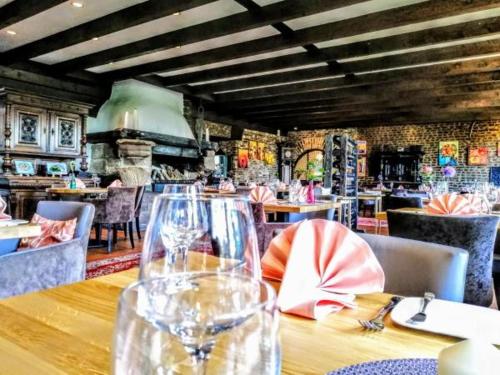 a restaurant with a table with wine glasses on it at Burg Wassenberg in Wassenberg