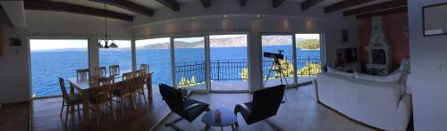 a dining room with a view of the ocean at THE VIEW **** in Račišće
