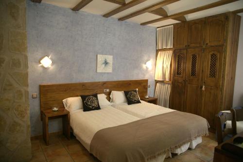 a bedroom with a large bed in a room at Casa Rural Baltasar in Aliaguilla